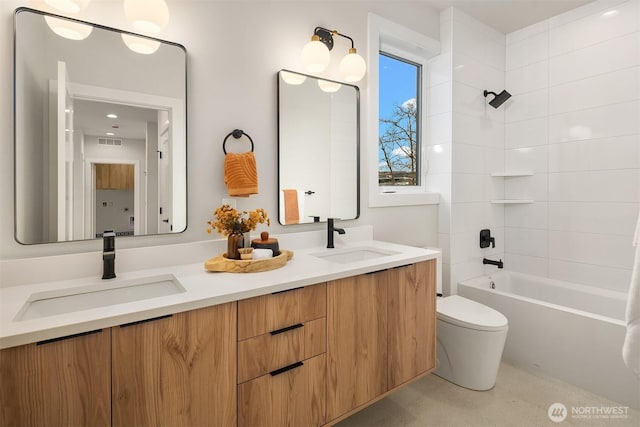 full bath with double vanity, visible vents, toilet, and a sink