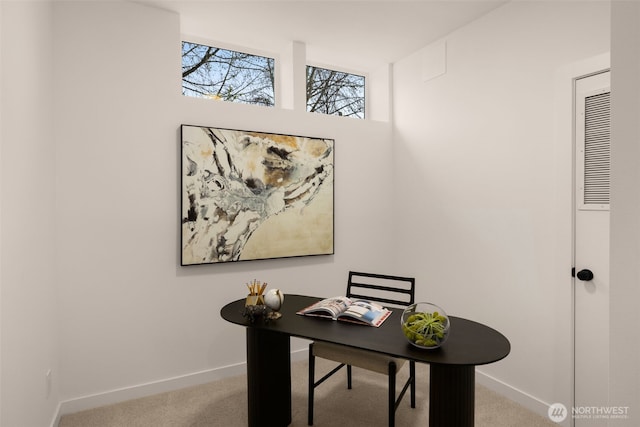 carpeted home office featuring baseboards