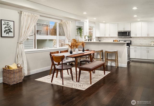 dining area with a wealth of natural light, dark wood-style floors, and recessed lighting