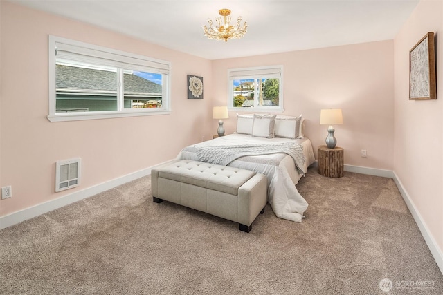 bedroom featuring visible vents, multiple windows, and carpet