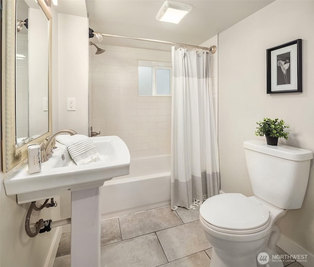 bathroom with tile patterned floors, toilet, and shower / bath combo with shower curtain