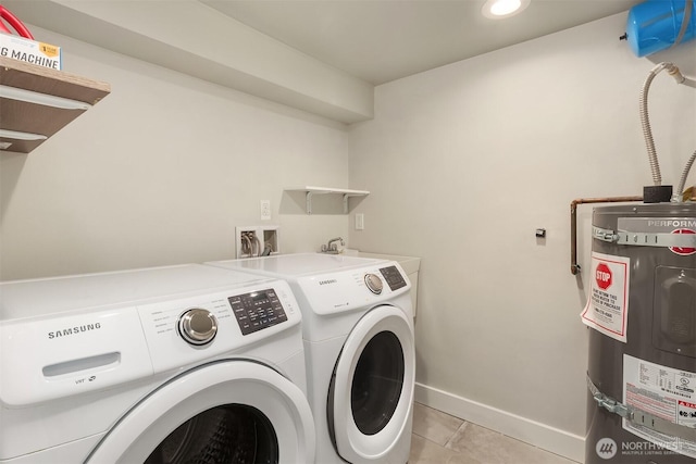 laundry room with baseboards, secured water heater, laundry area, light tile patterned flooring, and washer and clothes dryer