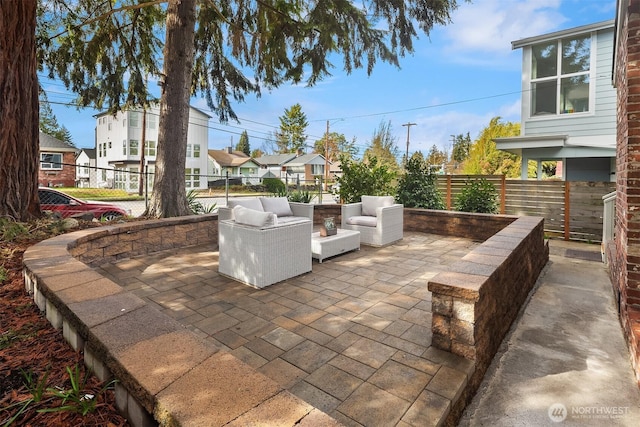 view of patio / terrace with a residential view, outdoor lounge area, and fence