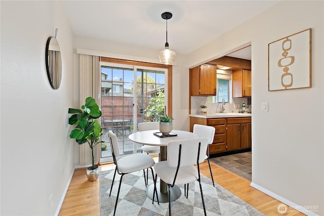 dining room featuring baseboards and light wood finished floors