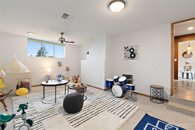 interior space featuring visible vents, baseboards, carpet, and ceiling fan