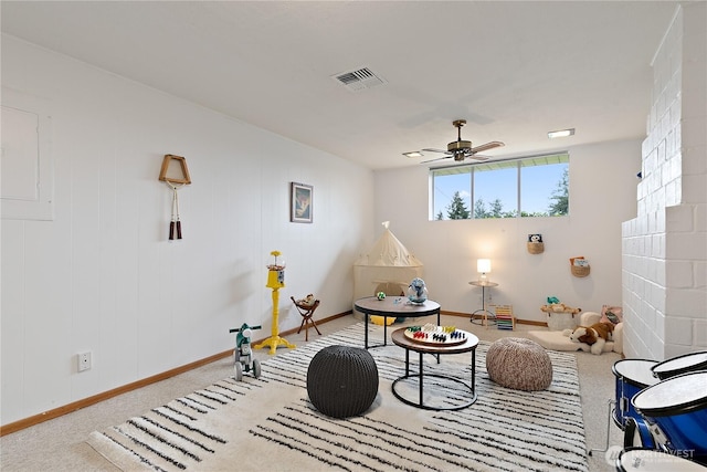 sitting room featuring baseboards, visible vents, carpet floors, and ceiling fan