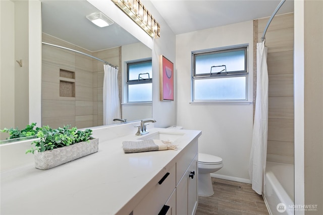 full bathroom featuring visible vents, toilet, wood finished floors, baseboards, and vanity