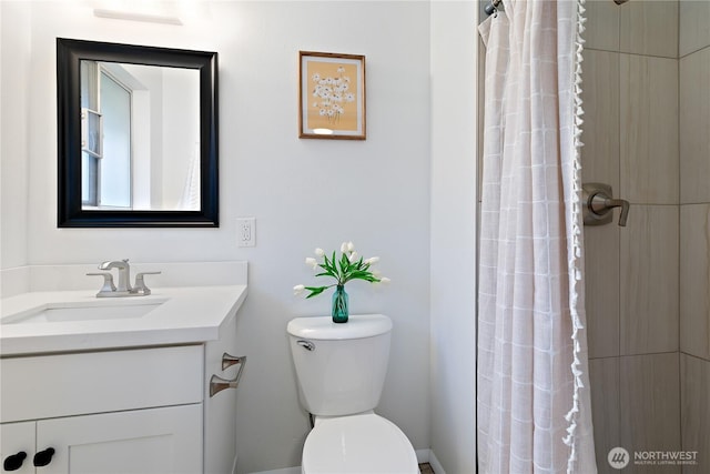 bathroom featuring a shower with shower curtain, toilet, and vanity