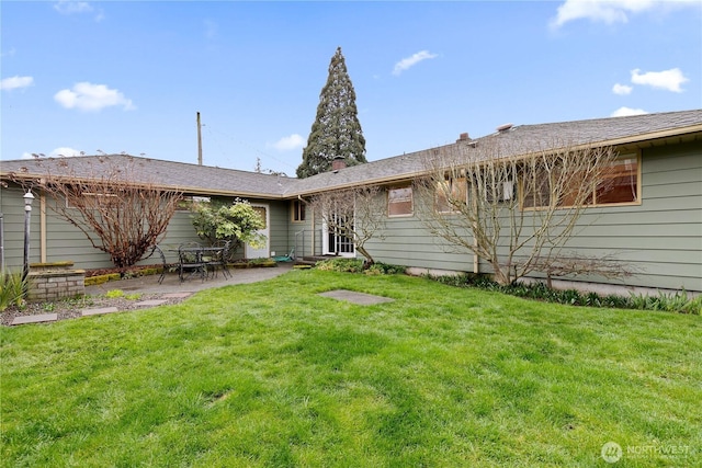 back of house featuring a yard and a patio