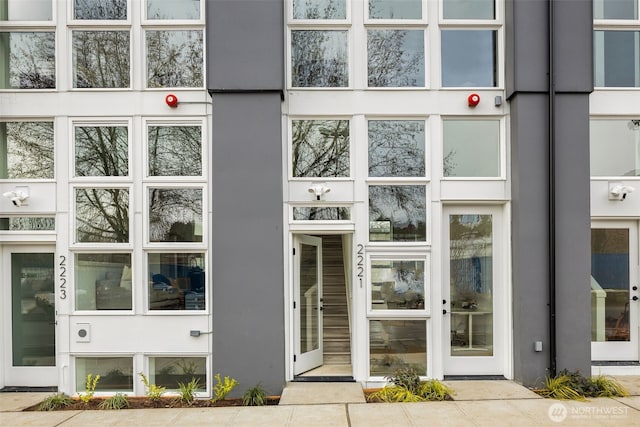 doorway to property with stucco siding