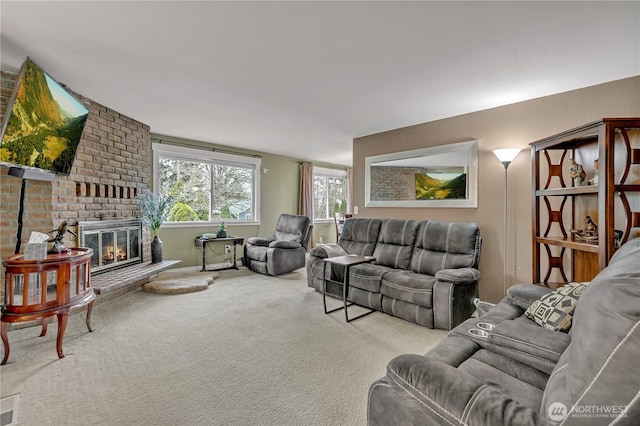 living room with carpet and a brick fireplace