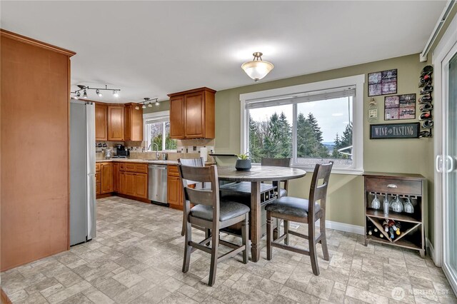 dining area with stone finish flooring and baseboards