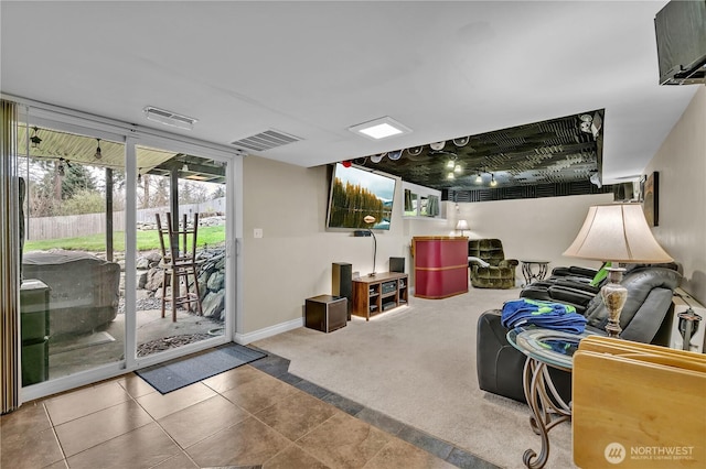 tiled living area featuring visible vents, carpet floors, and baseboards