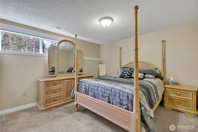 bedroom featuring visible vents, light colored carpet, a textured ceiling, and baseboards