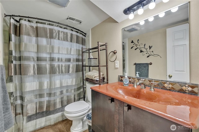 full bathroom featuring vanity, visible vents, curtained shower, tile patterned floors, and toilet