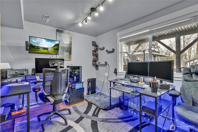 office space featuring wood finished floors and rail lighting