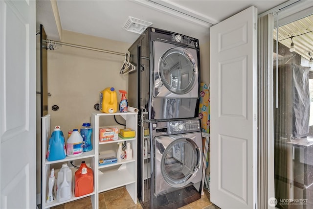 washroom featuring laundry area and stacked washer and clothes dryer