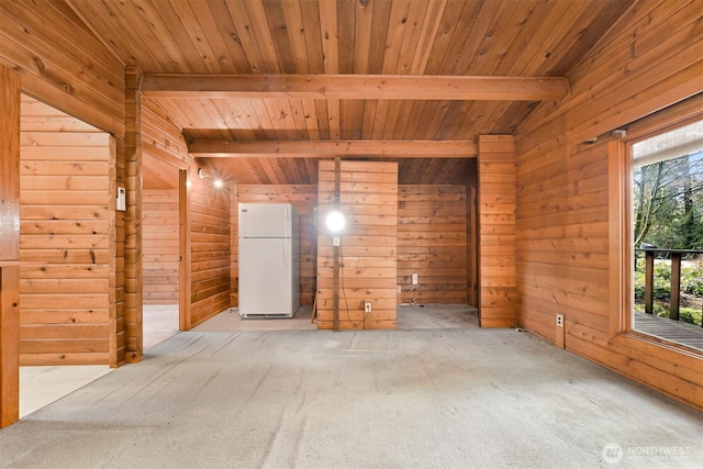 unfurnished room with beam ceiling, wooden walls, wooden ceiling, and light carpet