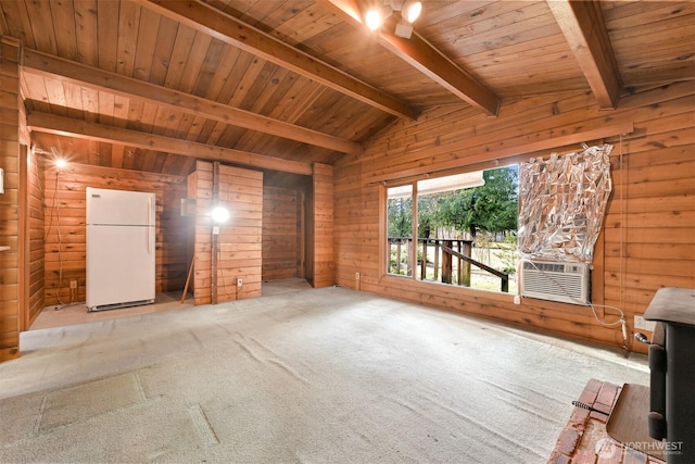 unfurnished living room with lofted ceiling with beams, carpet floors, wooden walls, and wood ceiling