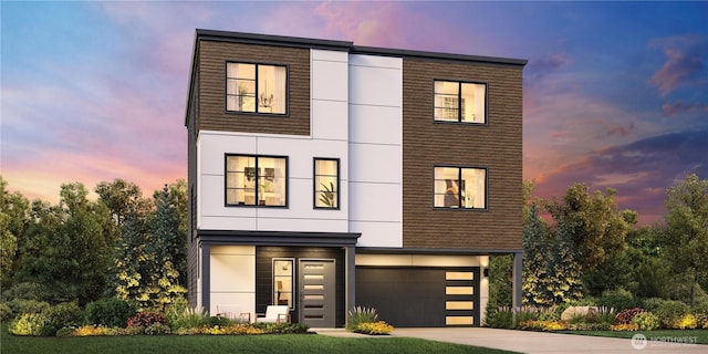 contemporary home with stucco siding, an attached garage, and concrete driveway