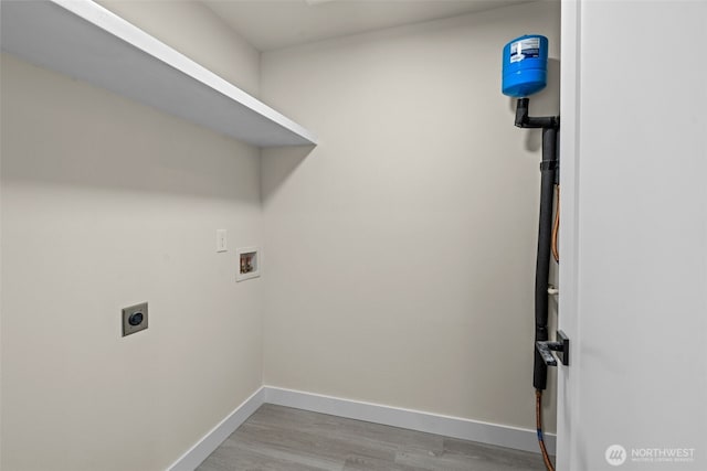 laundry room featuring baseboards, laundry area, hookup for a washing machine, light wood-style flooring, and hookup for an electric dryer