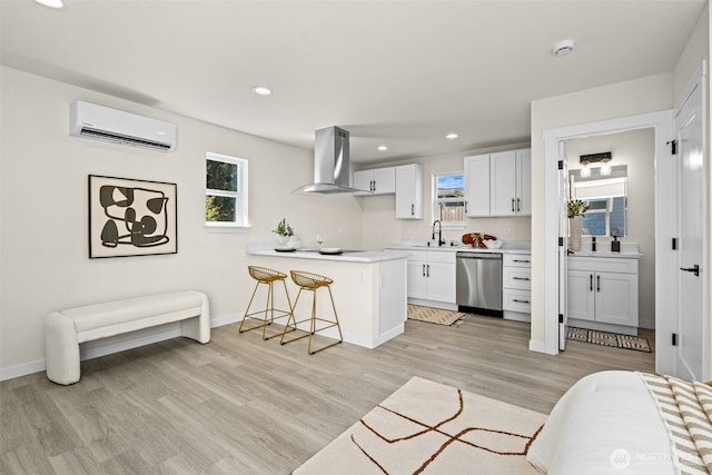 kitchen featuring a wall unit AC, ventilation hood, a peninsula, a sink, and dishwasher