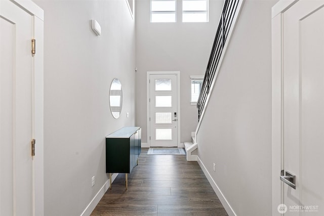 entrance foyer with baseboards, dark wood finished floors, and stairs