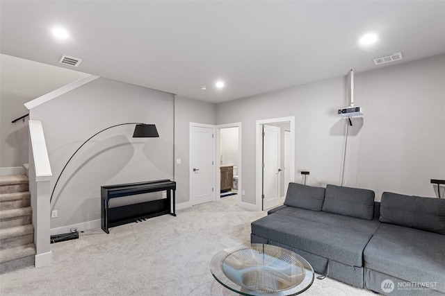 living area featuring visible vents, light carpet, recessed lighting, stairway, and baseboards