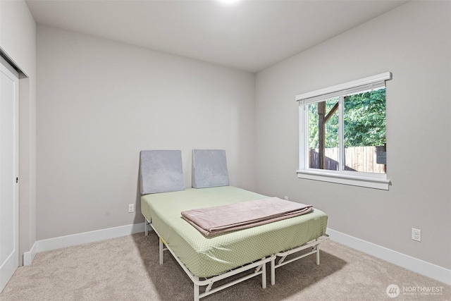 carpeted bedroom featuring baseboards