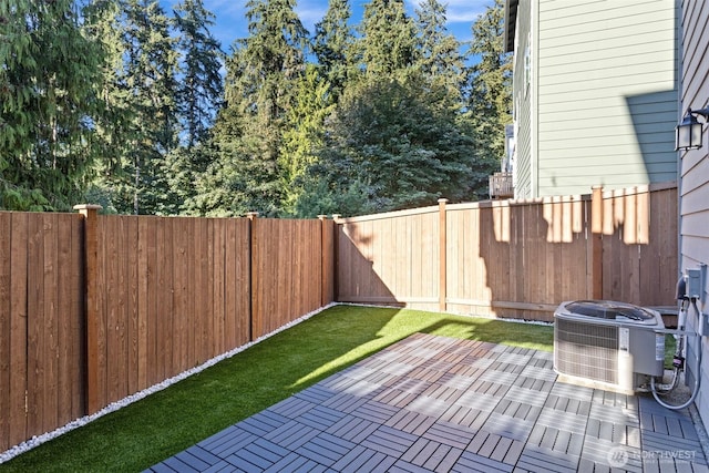 view of patio / terrace with cooling unit and a fenced backyard