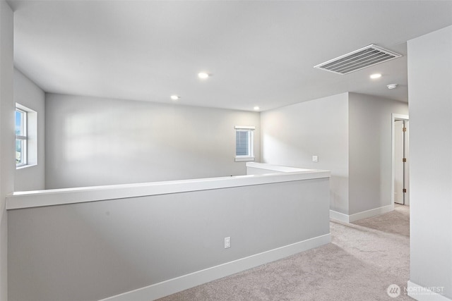 carpeted spare room with recessed lighting, visible vents, and baseboards