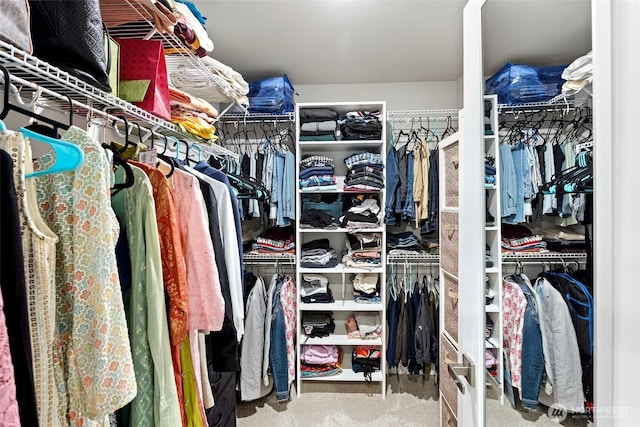 walk in closet with carpet