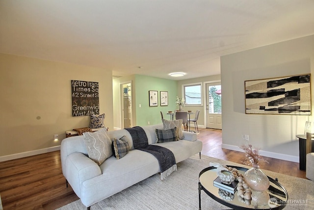 living room with baseboards and wood finished floors