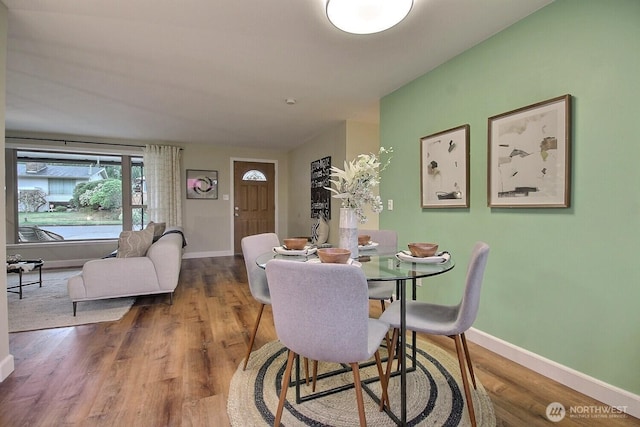 dining area featuring baseboards and wood finished floors