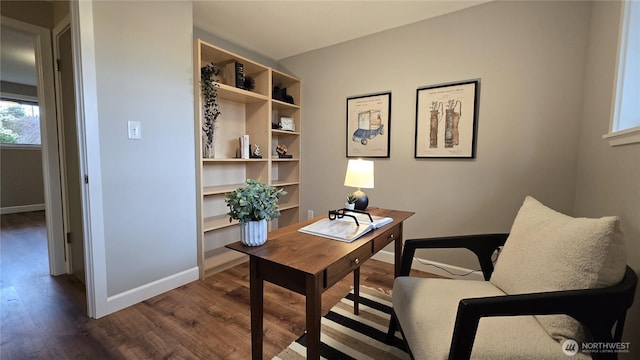 office space with dark wood finished floors and baseboards