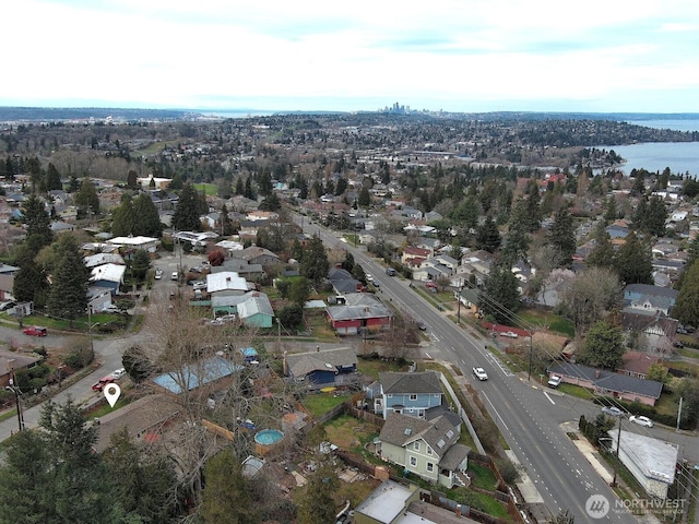 birds eye view of property with a water view and a residential view