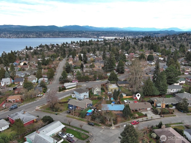 drone / aerial view with a residential view and a water and mountain view