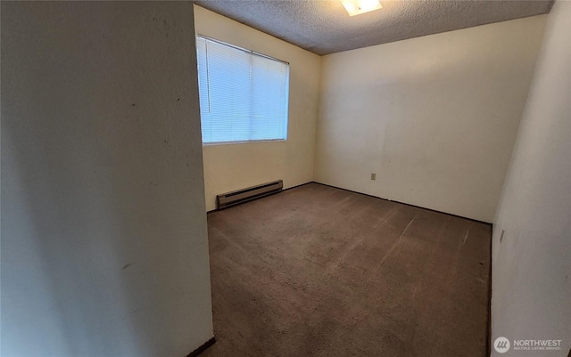 spare room with baseboard heating, a textured ceiling, and carpet