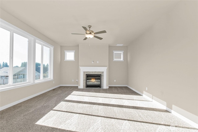 unfurnished living room featuring baseboards, carpet, and ceiling fan