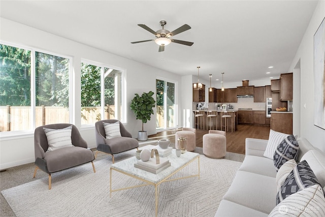 living area featuring recessed lighting, a ceiling fan, and baseboards