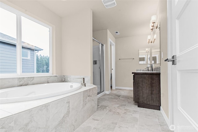 bathroom with vanity, a shower stall, a garden tub, and visible vents