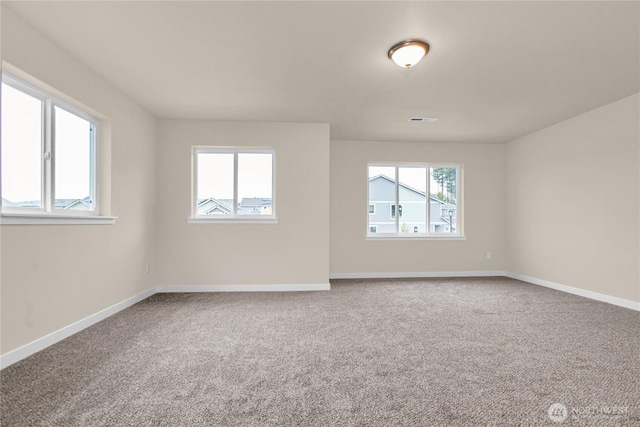 unfurnished room featuring visible vents, baseboards, and carpet flooring