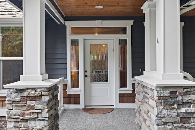 view of exterior entry featuring covered porch