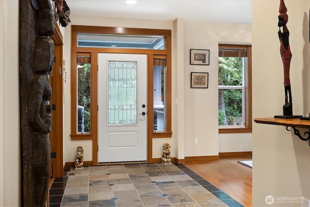 entrance foyer featuring baseboards and wood finished floors