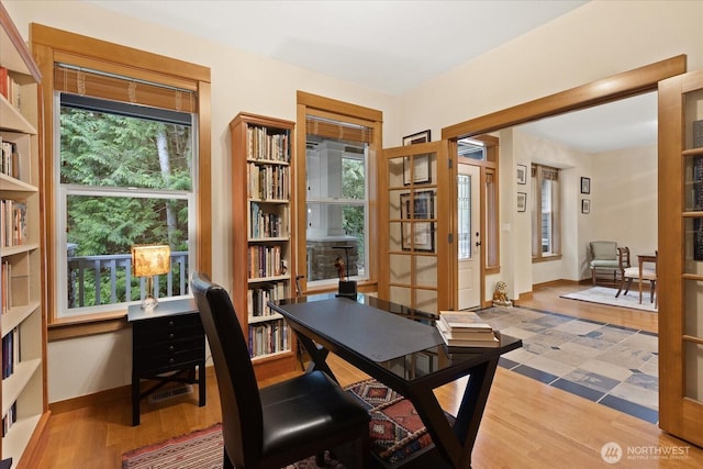 office area featuring wood finished floors, baseboards, and a healthy amount of sunlight