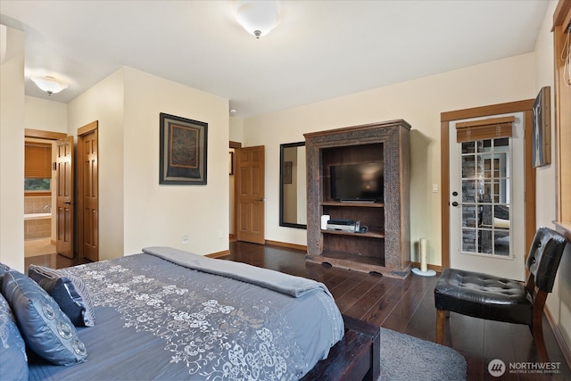 bedroom featuring wood finished floors and baseboards