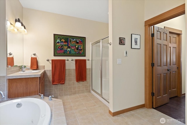 bathroom with tile patterned flooring, a shower stall, a bath, and vanity