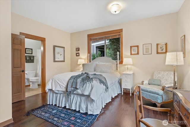 bedroom featuring dark wood finished floors and ensuite bath