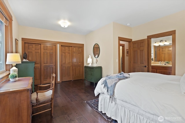 bedroom with dark wood finished floors and ensuite bathroom