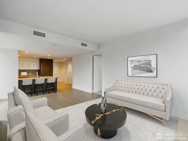 588 Bell St Unit 1603S, Seattle, WA 98121 - living room with light wood-style flooring, baseboards, and recessed lighting